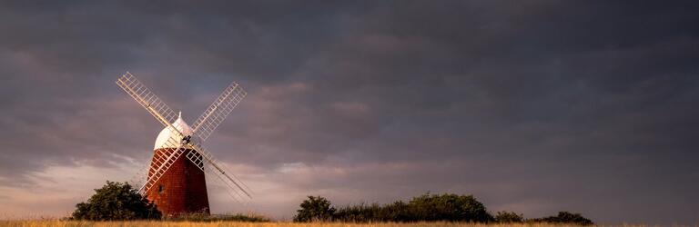 Artistic photo of Halnaker windmill under dark skies, by local photographer Jamie Fielding
