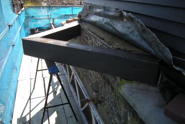 Photograph showing rotting reef deck partially restored mid-way through restoration.